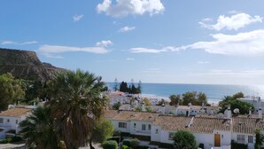 A coastal town with white buildings, palm trees, and a view of the sea. - WAKE UP TO THE SOUND OF THE SEA T1 CENTRAL-AIR CONDITIONING(FREE WIFI) 3' BEACH (Luz)