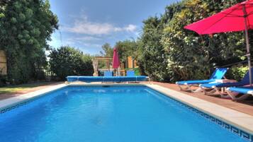 A heated pool, sun loungers