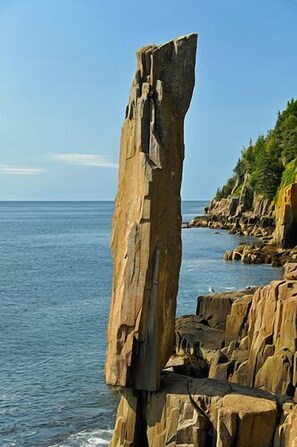 Une formation rocheuse côtière avec une étroite corniche qui s’avance dans la mer.