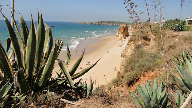 A beach with clear blue water, sandy shore, and rocky cliffs. - Vilamoura, Good location with sea view and swimming pools (Vilamoura)