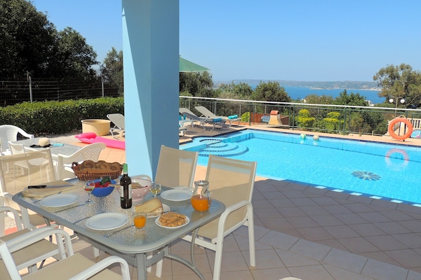 08 Nostalgia dining terrace with view over pool to the sea.
