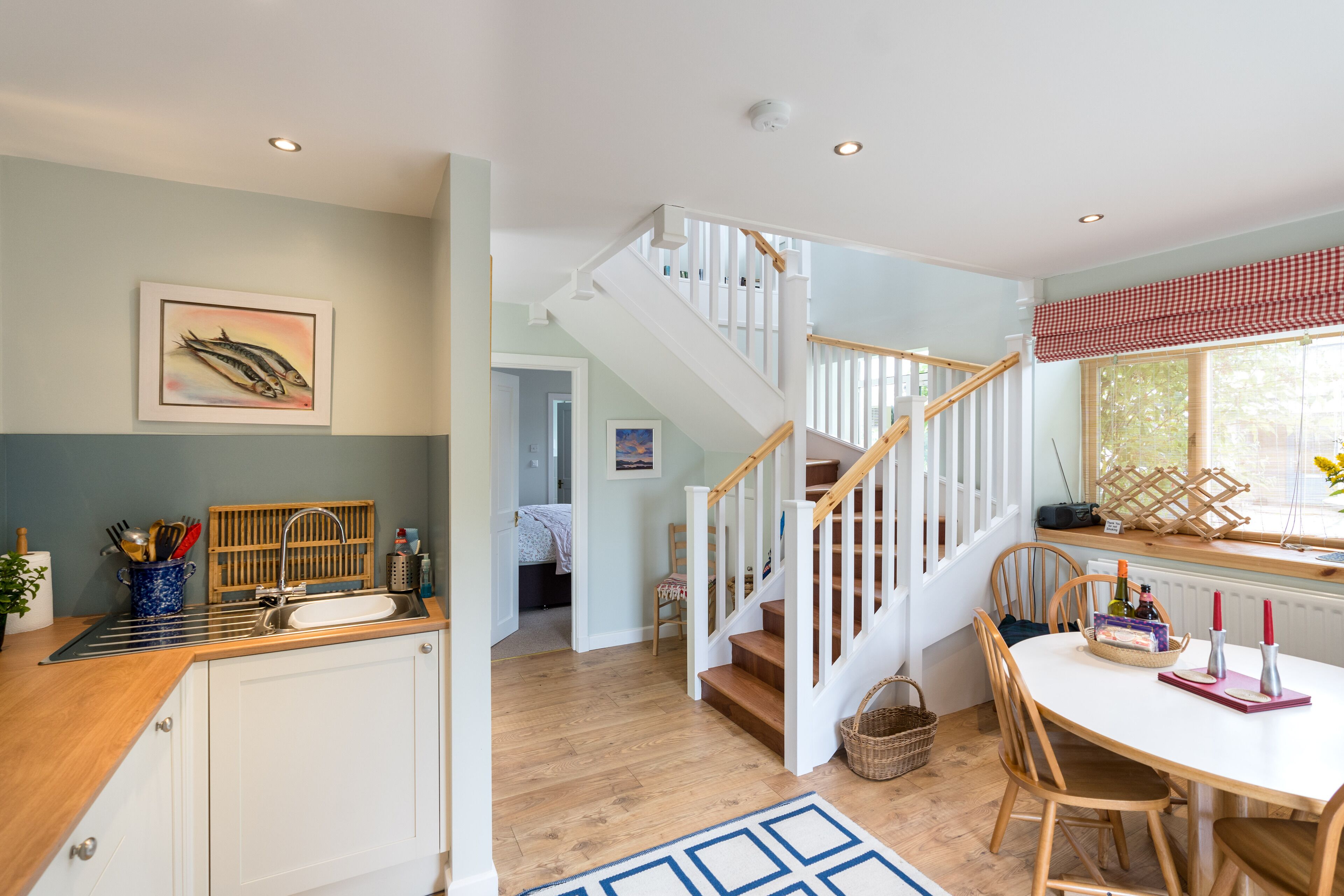 Open door to downstairs ensuite bedroom from kitchen/dining room Vorlich Cottage