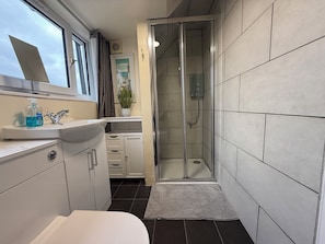 Shower, hair dryer, towels, toilet paper