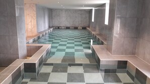 A modern indoor pool area with checkered floor tiles, marble walls, and built-in seating along the sides. - Domaine La Rosière - Villa for 50 people Indoor swimming pool, Tennis court, Cinema, etc. (Diemeringen)