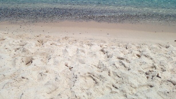 A beach with clear turquoise water and a sandy shore. - Costa Rei chalet 20 meters from the beach (Costa Rei)