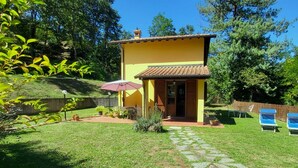 A yellow two-story house with a tiled roof, a small porch, and a stone pathway leading to the entrance. - Romantic Riverside Property, small private pool. WIFI . Walk to facilities (Borsigliana)