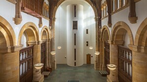 A corridor with arched ceilings and a ping pong table in the center.