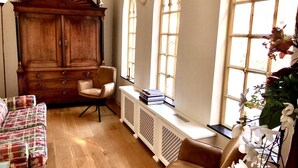 A room with a wooden cabinet, a white radiator, and a window with a view of the outside. - Exclusive location in an oasis of tranquillity in Hoorn (near Amsterdam).  (Hoorn NH)