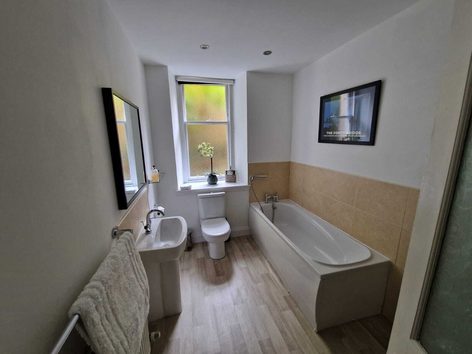 Bathtub, hair dryer, towels, soap