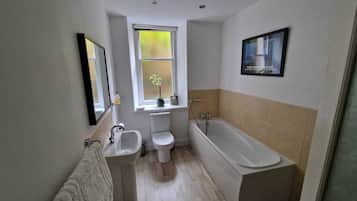 Bathtub, hair dryer, towels, soap