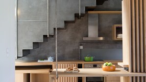 A modern kitchen with a wooden countertop, a green pot, and a fruit bowl. - Aggelos Brand New Exclusive Villa with Private Pool (Agrikies Villas) (Lefkada)