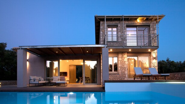 A two-story house with a swimming pool, outdoor seating, and a stone facade. - Aggelos Brand New Exclusive Villa with Private Pool (Agrikies Villas) (Lefkada)