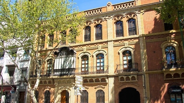 A historic building with arched windows and a balcony.