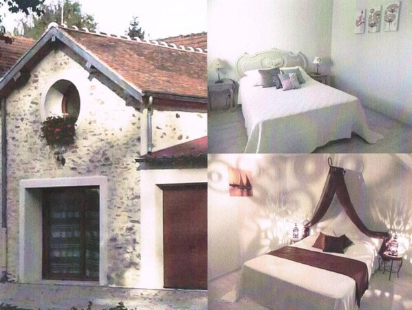 A stone building with a dormer window, a bed with a canopy, and a small table with a lamp. - Leudon En Brie: Cottage 5 pers near Provins (Leudon-En-Brie)