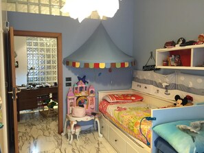 Cozy child's retreat with a bed, desk, and chair, perfect for a fun and imaginative space.