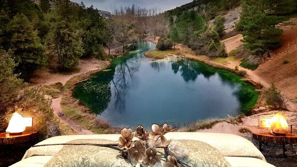 A bedroom with a view of a lake surrounded by trees. - Self catering La Puerta del Rio Lobos for 10 people (San Leonardo de Yague)