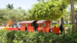 Un petit train miniature dans un parc.