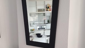 A fireplace with a black mantel and a mirror above it. - EASY WALK TO MAX BEACH LOVELY APT  WI-FI  STUNNING SEA/POOL VIEWS +ELEVATOR/LIFT (Riviera del so/l La cala)