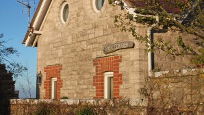 A stone building with a red-tiled roof, a chimney, and a sign that reads "The Lookout." - The Lookout - panoramic views; log fire; ONE-dog-friendly, local beaches. (Kingston)
