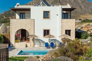 A modern two-story house with a swimming pool, outdoor seating, and a mountainous backdrop. - Aeolus villa with private pool, stunning sea views,  beach in 5min, Wifi (Makrigialos)