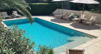 Private villa with mature gardens, 2 minutes walk from sandy beach.