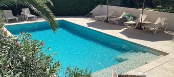 Private villa with mature gardens, 2 minutes walk from sandy beach.