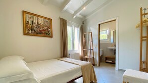 A bedroom with a single bed, a wooden ladder, a bathroom with a sink, and a painting on the wall. - Private villa with mature gardens, 2 minutes walk from sandy beach. (sant lluis)