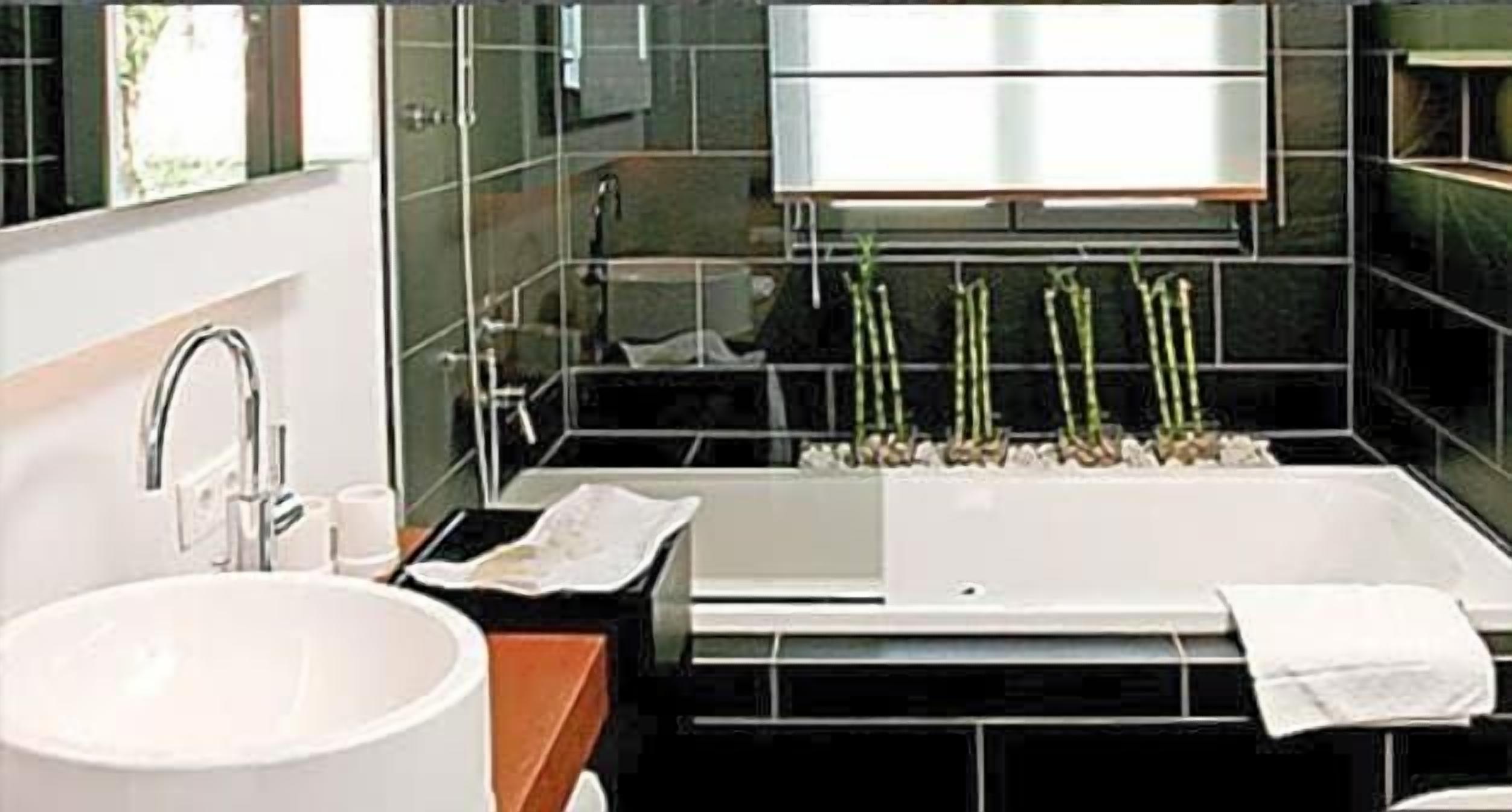 A modern bathroom with a large sink, a bathtub, and a mirror above the sink.