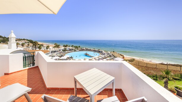 A balcony with a view of a beach and a swimming pool. - This is Sea View !!! (Almancil)