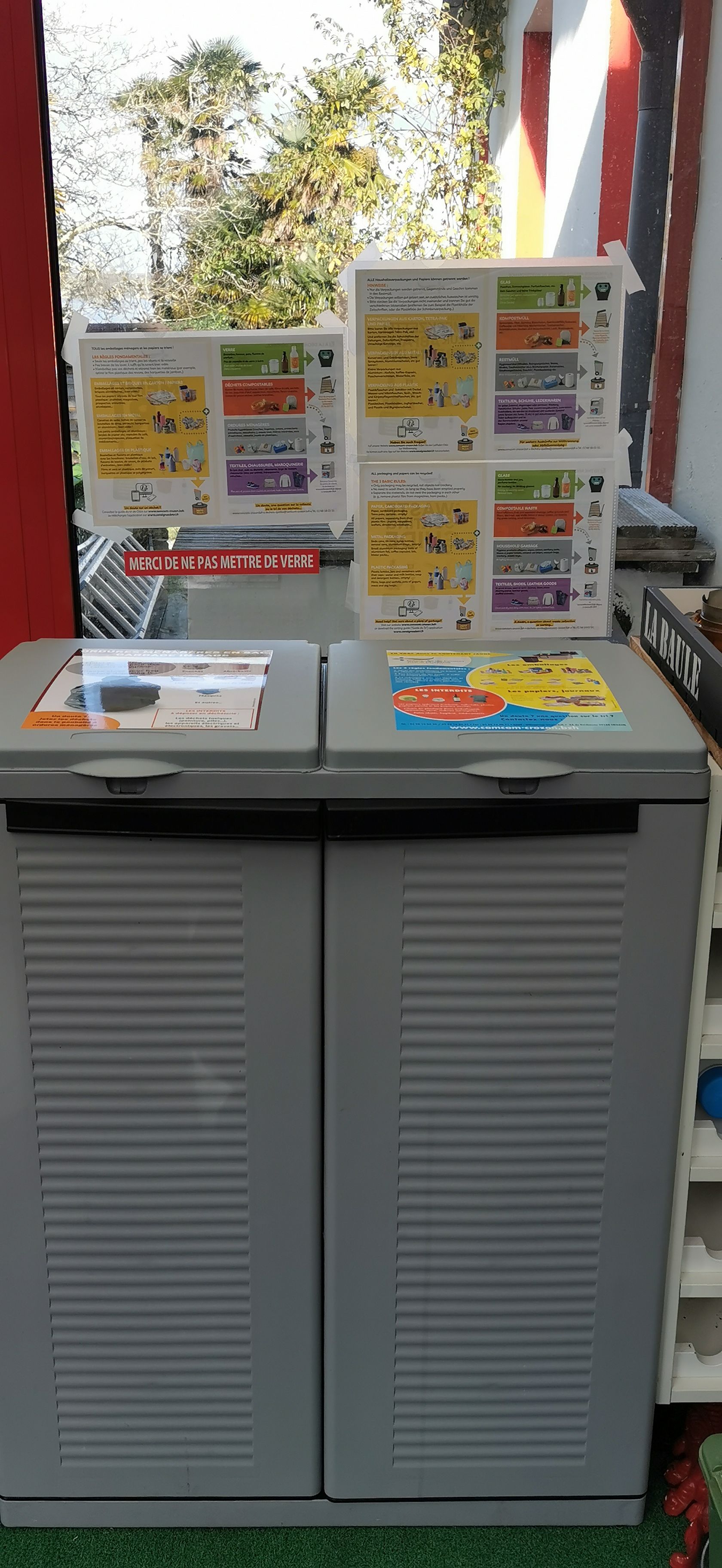 A recycling station with labeled bins for different materials.