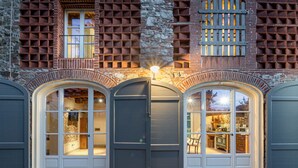 A building with a stone facade, a large arched entrance, and a visible interior with a dining area. - A Romantic Farmhouse with Pool in 10 mins walk away from the Walls of Lucca (Monte San quirico)