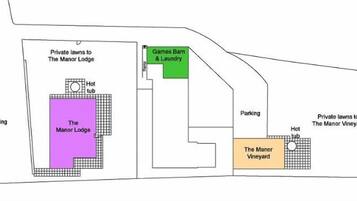 A layout of The Manor Lodge with private lawns, a hot tub, parking, and a Games Barn & Laundry.