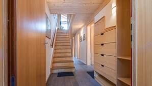 A wooden staircase leading to a loft bedroom with a skylight. - Duplex Penthouse in Chalet Luna (Wengen)