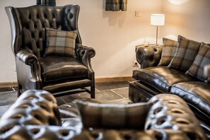 Massive leather wing chair is just what the doctor ordered after a hard day