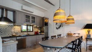 A modern kitchen with grey cabinets, a tiled backsplash, and a dining area with a large table and chairs. - Apartment/ flat - Lagnes-L'Isle-sur-la-Sorgue (lAGNES)