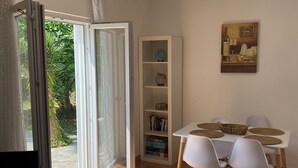 A modern living room with a dining area, a bookshelf, and a painting on the wall. - Villa in Gosici, Radovici. Private Pool, BBQ, peaceful location, stunning views. (Gošići)