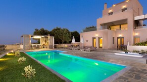 A heated pool, sun loungers