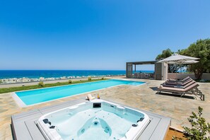 A heated pool, sun loungers