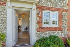 Front door leading to entrance hall