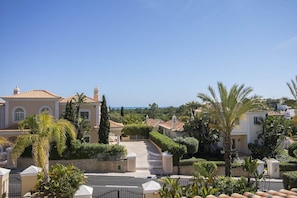 Stunning Mediterranean-style homes set amidst lush greenery and manicured hedges.