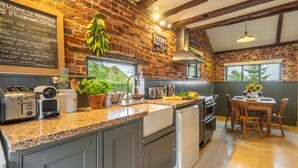 Eine Küche mit Granit Arbeitsplatten, einer Spüle und einem Essbereich mit Tisch und Stühlen.