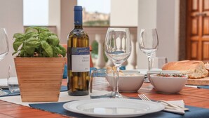 A table set with a bottle of wine, a bowl of salad, and a loaf of bread. - Exclusive Villa with Spectacular Panoramic Views - Excellent location ★★★★★ (Pescara)