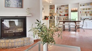 A living room with a fireplace, a dining area, and a kitchen. - LA FEUILLERE, 17 CENTURY MANSION.  (Saint Antonin sur Bayon)