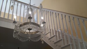 A chandelier with multiple lights hanging from a white balustrade. - Family Friendly Spacious Home On Large Grounds With Panoramic Views (Aughrim)