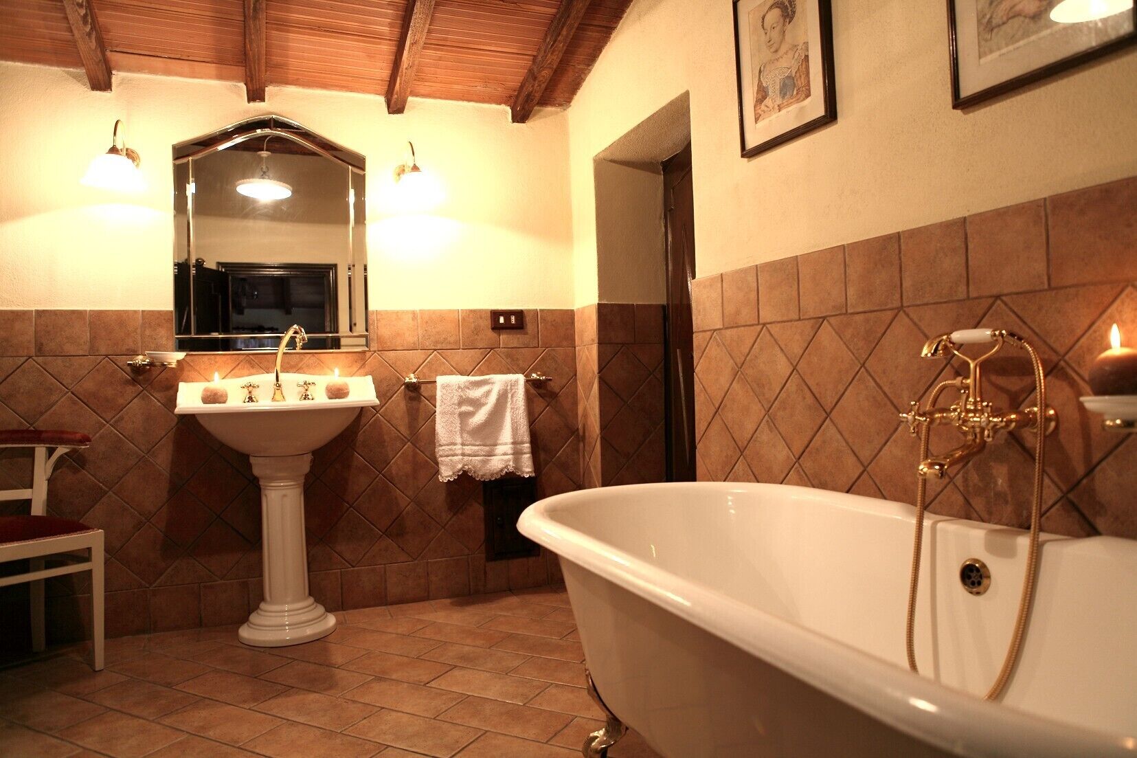A bathroom with a freestanding bathtub, a pedestal sink, and a mirror above the sink.