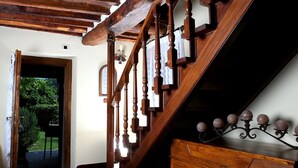 A wooden staircase with a dark finish and a decorative iron railing. - Villa (Pieve Camaiore)