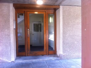 A wooden door with glass panels, leading to a staircase.