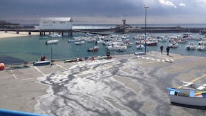 A harbor with numerous boats docked, a lighthouse, and a pier extending into the water. - House with large garden classified 3 stars 5 km from the sea (Concarneau)