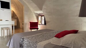 A bedroom with a bed, a red chair, a desk, and a television. - House of character in Feliceto Corsica, classified 4 stars (Feliceto)
