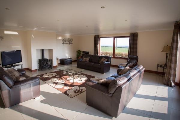 Large lounge with underfloor heating,log burner doors onto patio fantastic views
